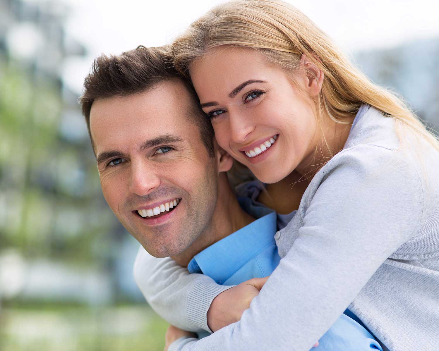 man and woman smiling together